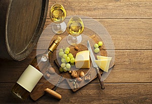 White wine bottle and glass with barrel background