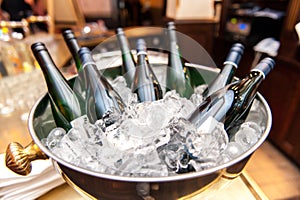 White wine bottles in bowl of ice