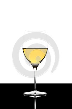 White wine glass on a black board isolated and backlit and refl