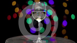 White wine in glass with blurred lights