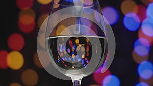 White wine in glass with blurred lights