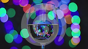 White wine in glass with blurred lights