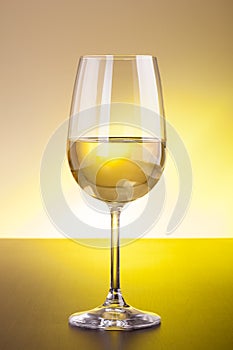 White wine glass on wooden table