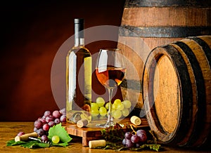 White wine and grapes with barrel