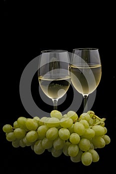 White wine and grapes on black