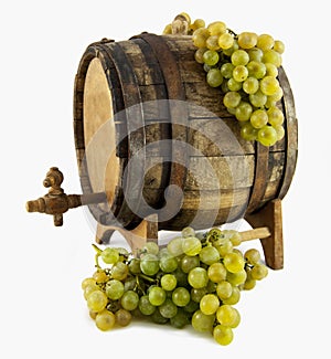 White wine, grapes and old barrel on white backgro