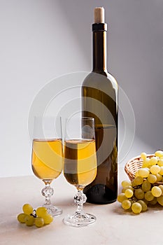 White wine and grapes. White wine in glasses, bottle of wine and
