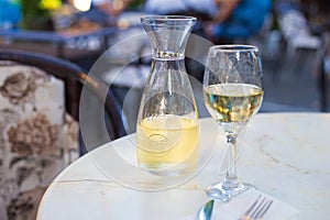 White wine in a liter bottle on a table in a cafe