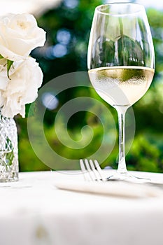 White wine in luxury restaurant on summer garden terrace, wine tasting experience at winery in the vineyard, gourmet
