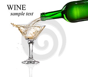 White wine pouring from the bottle intro the glass photo