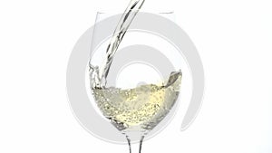 White wine pouring into glass in slow motion