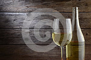 White wine and rustic wooden background