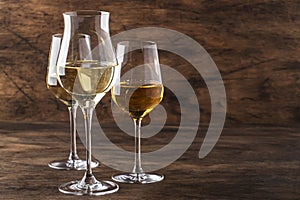 White wine set. Wine tasting, the most popular varieties of white wines in wine glasses on vintage wooden table in rustic style,