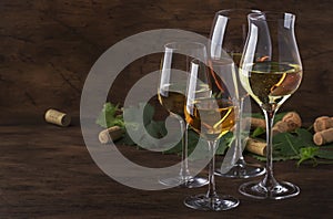 White wine set. Wine tasting, the most popular varieties of white wines in wine glasses on vintage wooden table in rustic style,