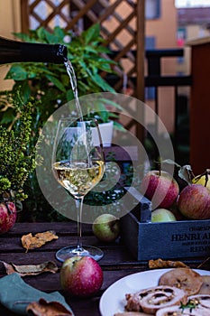 White wine or sider glass on rustic wooden table