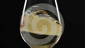 White wine swirling in a large wine glass