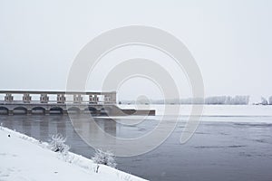 White winter tree,river and dam