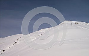 A white winterlandscape with blue sky,