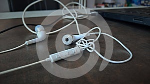 white wired earphones tangled up selective focus