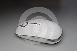 white wireless computer mouse isolated on dramatic technology modern presentation