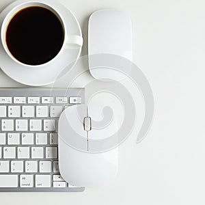A white wireless computer mouse and a white touchpad are placed