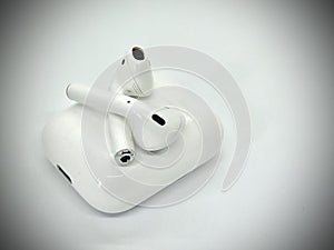 White Wireless Earbuds Out of Charging Case photo