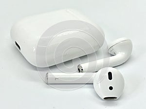 White Wireless Earbuds Out of Charging Case photo