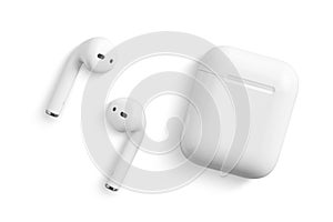 White wireless earphone or headphones for using with smartphone, isolated on a white background.