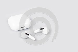 White wireless earphones on a gray background
