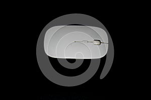 White wireless mouse on black background
