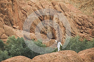 White woman walking on background of Todra gorge canyon landscape in Morocco