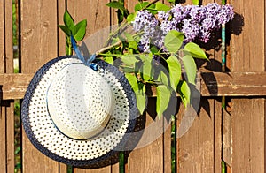 White women's hat and branch of lilac