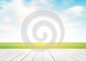 White wood floor foreground with football green field with cloud blue sky background. Landscape outdoor sport