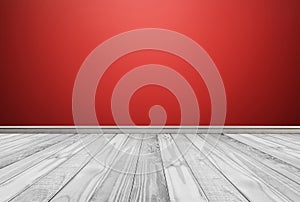 White wood floor panels with red wall background