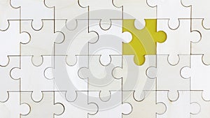White Wood jigsaw puzzle on yellow background with copy space.
