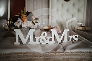 a white wood Mr Mrs letter on the chair