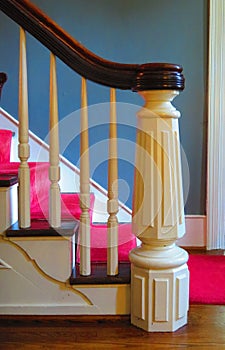 White wood staircase with tapered newel post