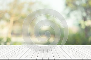 White wood table top on green blurred background,space for montage product