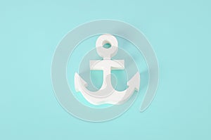 White wooden Anchor model on blue background - Nautical background