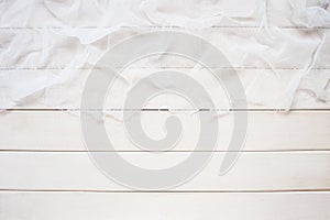 White wooden background with cheesecloth
