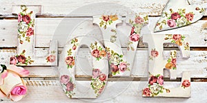 White wooden background with vintage style letters forming word LOVE