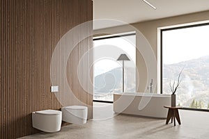 White and wooden bathroom with tub and toilet