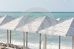 White wooden beach umbrellas on the beach. Travel concept