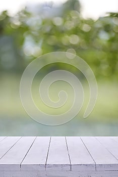 White wooden board empty table blur trees background