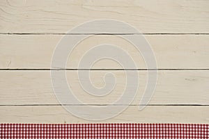 White wooden boards with red checkered tablecloth