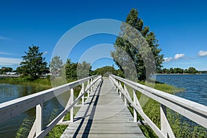 a white wooden bridge over the water