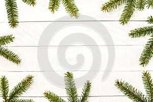 White wooden Christmas background. Border decorated fir branches