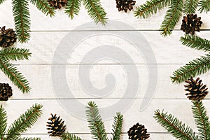 White wooden Christmas background. Border decorated fir branches and pin cones. Copy space for holiday greetings. lovely