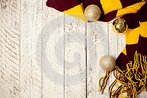 White wooden Christmas background. Empty space for text. Happy New Year. Christmas balls, garland, brown-red scarf