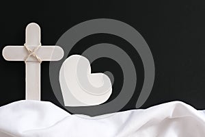 White wooden cross and fabric as symbol of heaven. Funeral backdrop and sympathy card design.